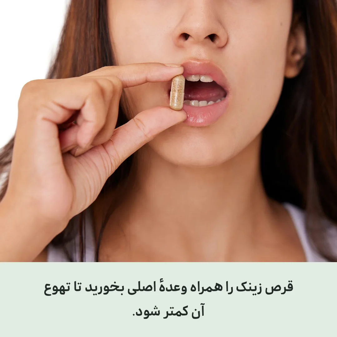 خانمی که کنار میز غذا، قرص را با لیوان آب برمی‌دارد